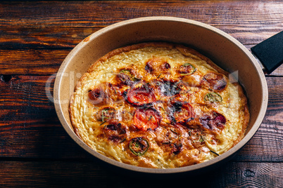 Frittata with chorizo, tomatoes and chili peppers.