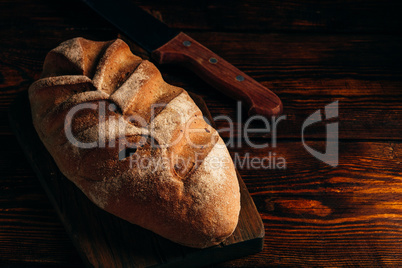 Homemade loaf on cutting board.