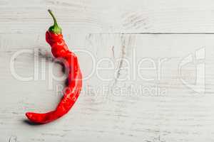 Chili pepper on wooden background.