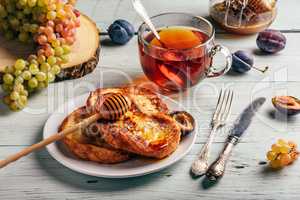 French toasts with honey, fruits and tea