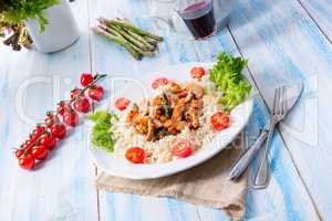 Turkey fricassee on rice with asparagus and paprika