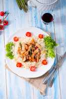 Turkey fricassee on rice with asparagus and paprika