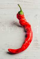 Chili pepper on wooden background.