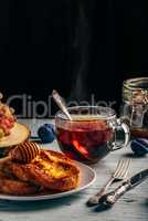 French toasts with honey, fruits and tea