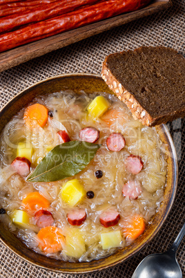 rustic sauerkraut soup with bacon and sausage