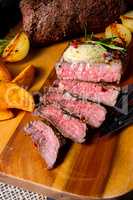 rustic medium butter beef steak with herbs and potato wedges