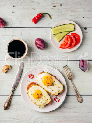 Breakfast toasts with vegetables and fried egg with cup of coffe