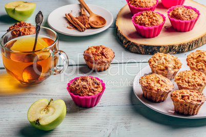 Oatmeal muffins with apple and cup of green tea.