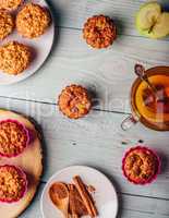 Oatmeal muffins with apple and cup of green tea.