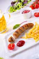 delicious bratwurst with rolls and beer