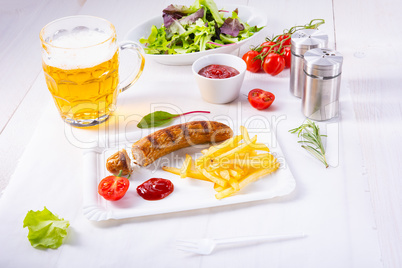 delicious bratwurst with rolls and beer