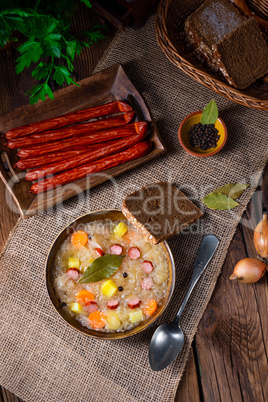 rustic sauerkraut soup with bacon and sausage