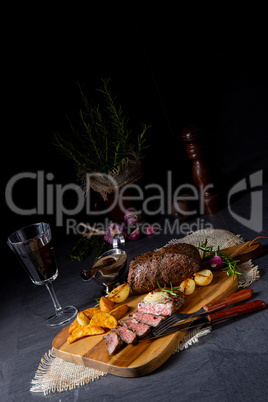 rustic medium butter beef steak with herbs and potato wedges