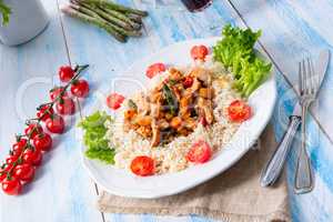 Turkey fricassee on rice with asparagus and paprika