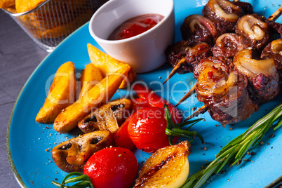 cattle shashlik skewers with grilled vegetables on a caucasian