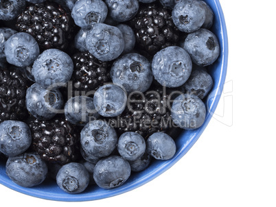 Forest berries (blueberry,bramble) in a ceramic blue  bowl. Top