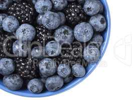 Forest berries (blueberry,bramble) in a ceramic blue  bowl. Top