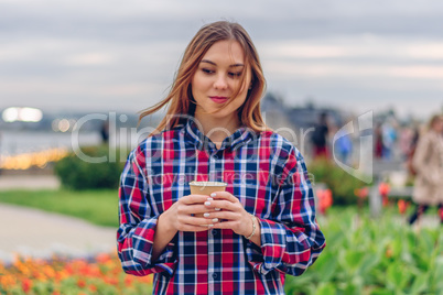 Beautiful young woman holding coffee cup