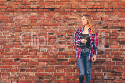 Portrait of young woman in shirt and jeans