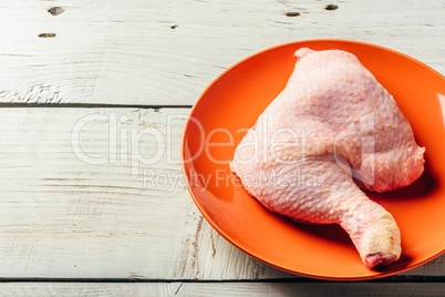 Chicken leg on orange plate
