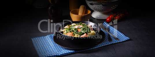 pappardelle pasta with creamed spinach and fried salmon