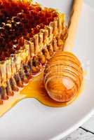 Honeycomb on plate with honey dipper