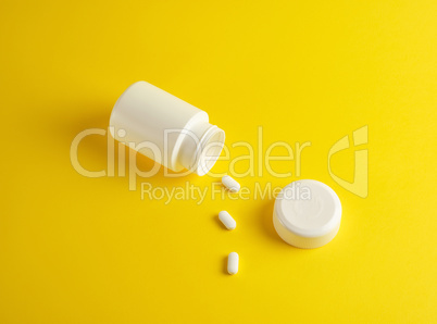 open white plastic jar for medicines and oval pills
