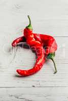 Red chili peppers on wooden background.