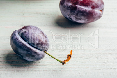 Plum on wooden surface