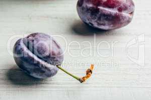 Plum on wooden surface