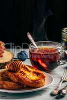 French toasts with honey, fruits and tea