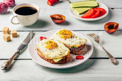 Bruschettas with vegetables and fried egg, cup of coffee and som