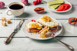 Toasts with vegetables and fried egg and cup of coffee