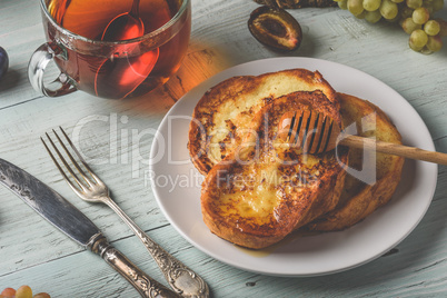 French toasts with honey, fruits and tea