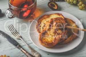 French toasts with honey, fruits and tea