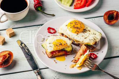 Sandwiches with vegetables and fried egg and cup of coffee