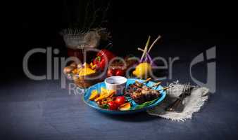 cattle shashlik skewers with grilled vegetables on a caucasian