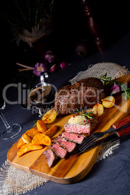 rustic medium butter beef steak with herbs and potato wedges