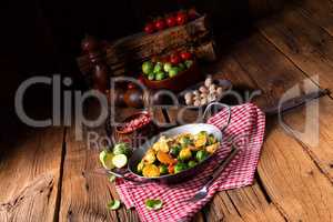 Brussels sprouts potato pan with bacon in rustic style