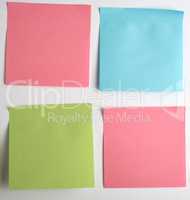 pink, blue, green paper stickers pasted on white  background
