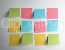 pink, blue, green paper stickers pasted on white  background