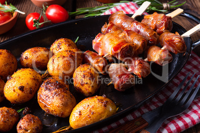 Rustic dates wrapped in bacon and young roasted potato.