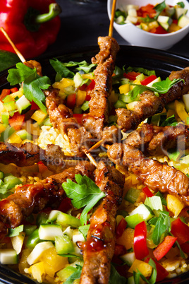 Lamb skewers with curry rice and different vegetables