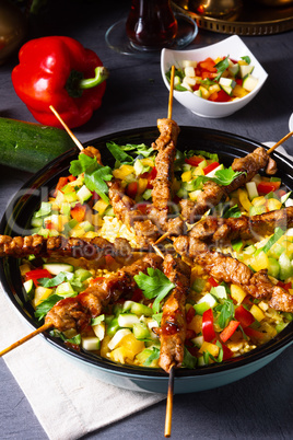 Lamb skewers with curry rice and different vegetables