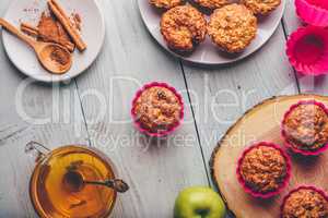 Oatmeal muffins with apple and cup of green tea.