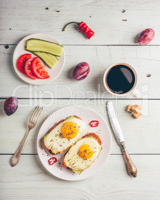 Breakfast toasts with vegetables and fried egg with cup of coffe