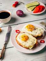 Toasts with vegetables and fried egg and cup of coffee