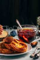 French toasts with honey, fruits and tea