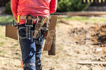 Cement Construction Worker With Toolbelt Holding Various Trowels