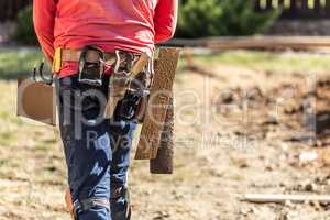 Cement Construction Worker With Toolbelt Holding Various Trowels